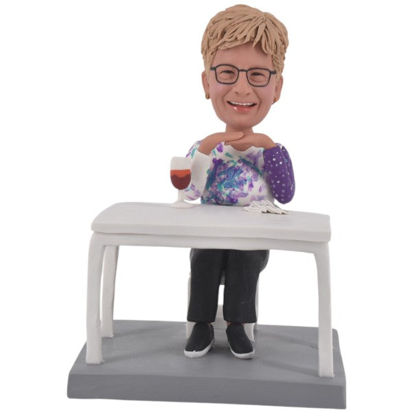 Personalized mother Bobblehead doll sitting at the table
