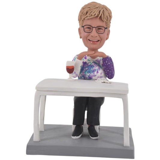Personalized mother Bobblehead doll sitting at the table